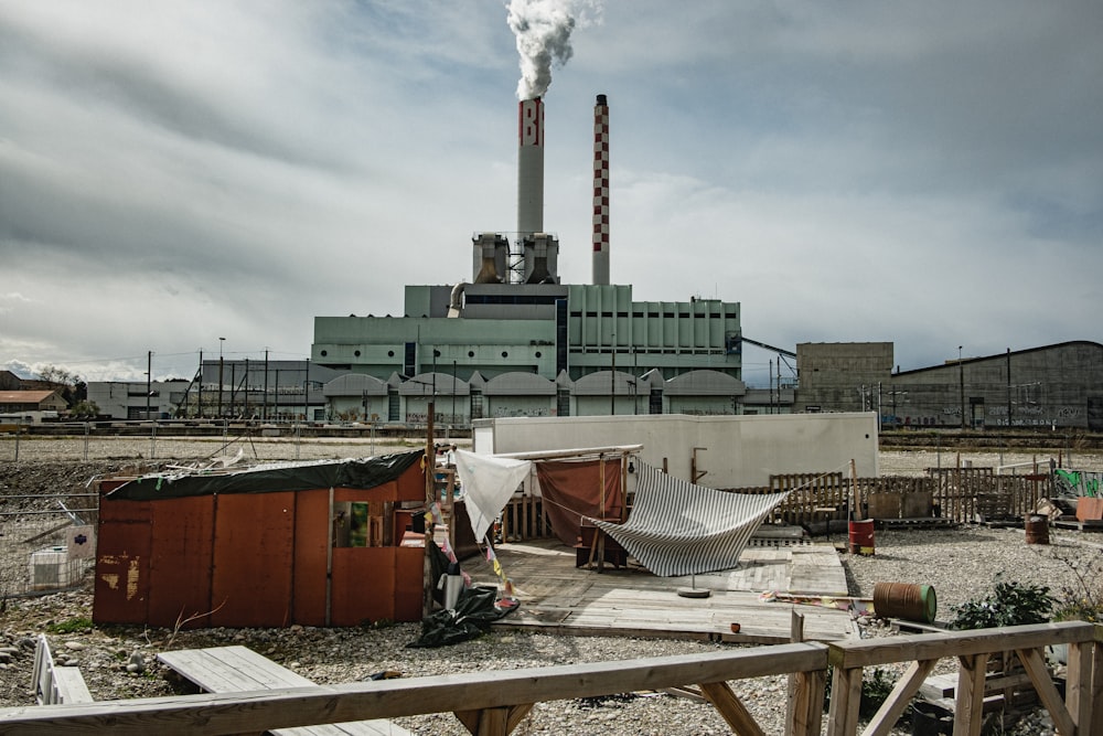 a factory with a hammock in the foreground