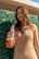 Close-up of a happy customer holding a colorful tropical kit from Tropi Alma.