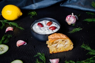 Close-up of a vibrant tzatziki chicken dish garnished with fresh cucumber slices and herbs.