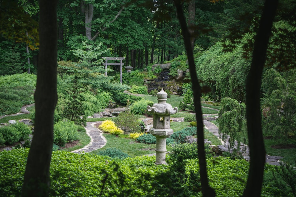 a garden with a statue in the middle of it