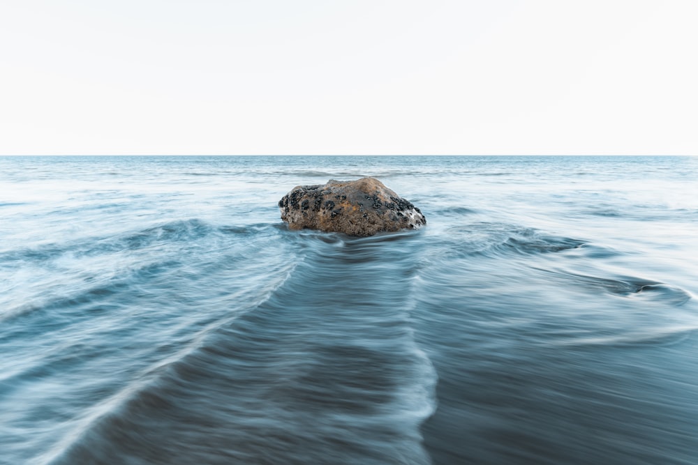 a rock in the middle of the ocean