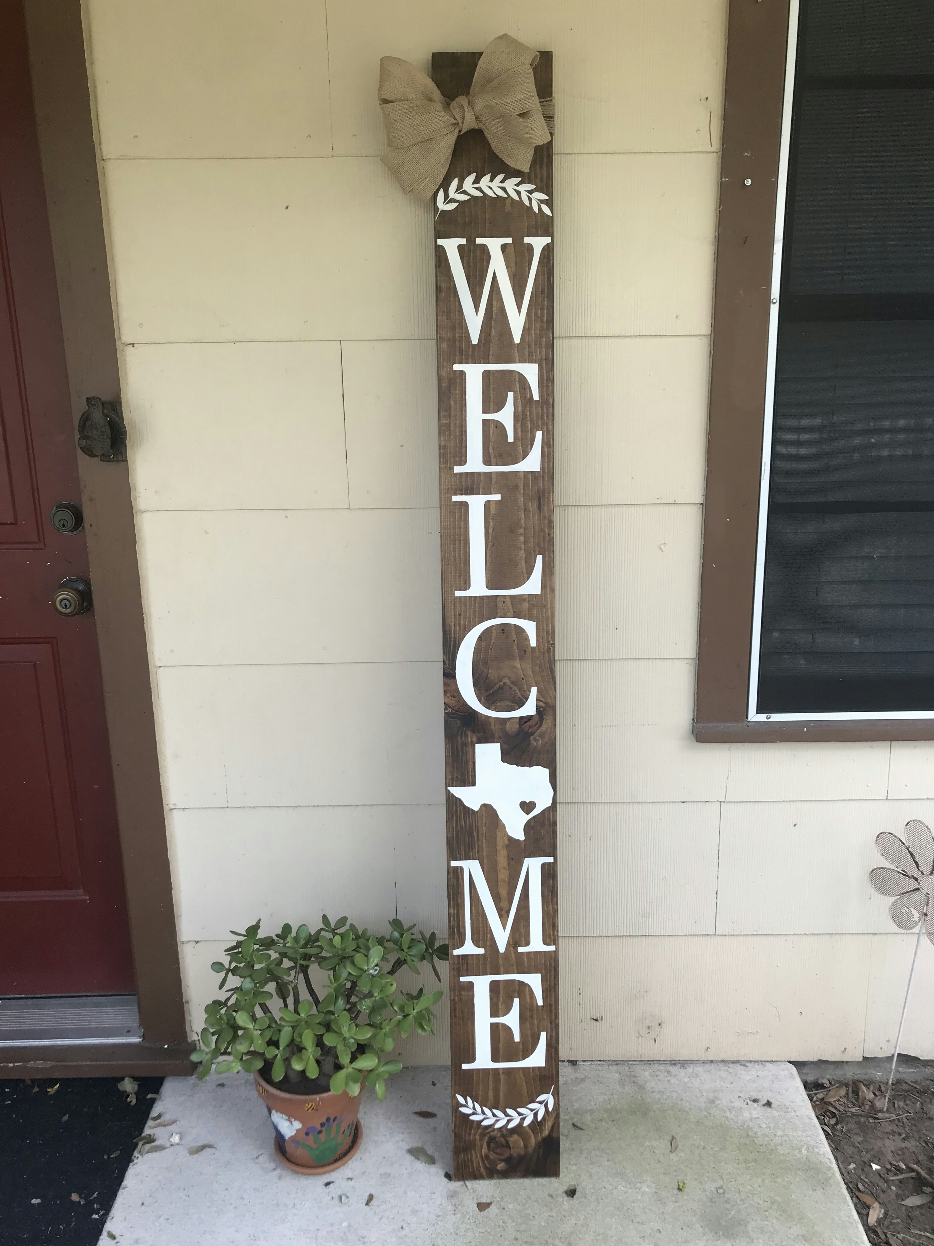 A wooden welcome sign sitting in front of a house photo – Free Plant ...