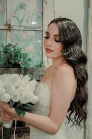 Bride with smooth, radiant airbrush makeup and delicate flower adornments.