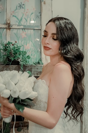 Bride smiling with soft waves and natural makeup on her wedding day.