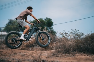 a person riding a bike on a dirt road