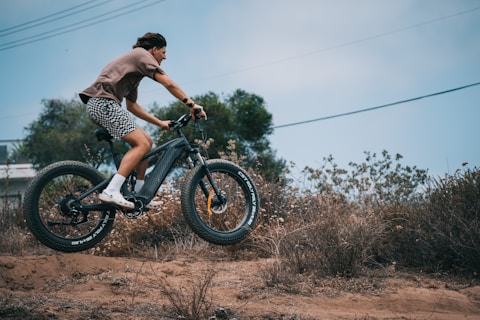a person riding a bike on a dirt road