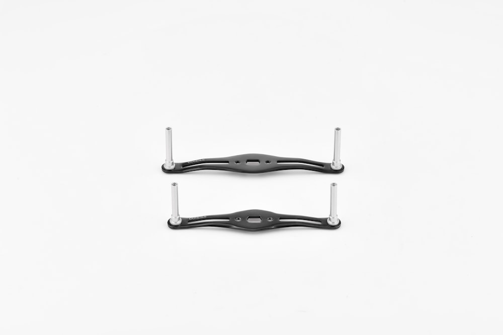 a pair of black handles on a white background