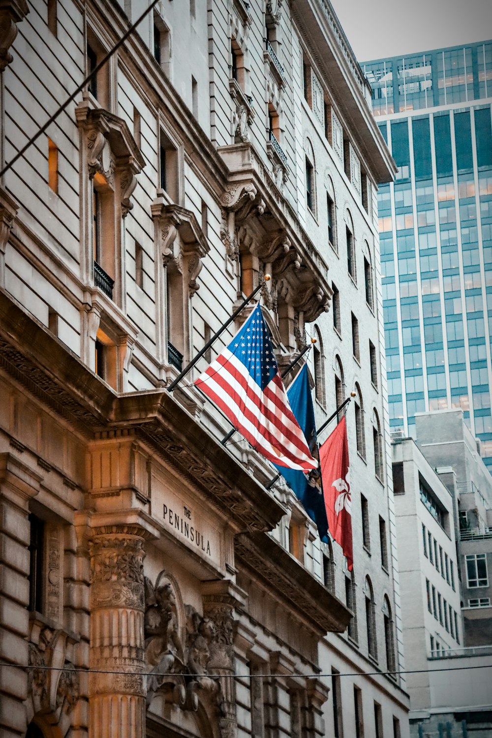 an american and canadian flag hanging from a building