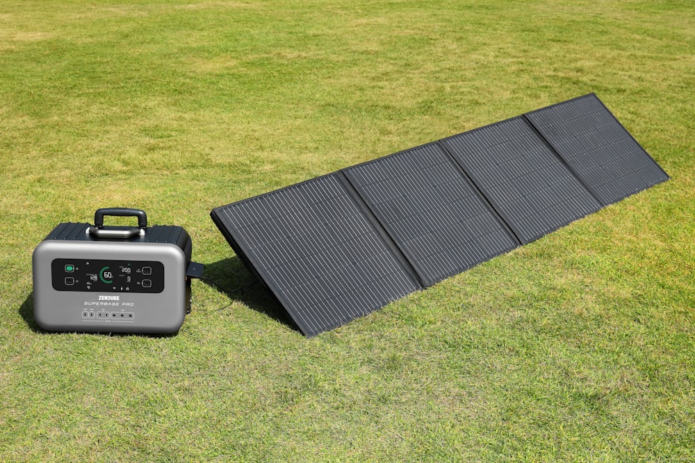 a solar panel and a portable charger on the grass