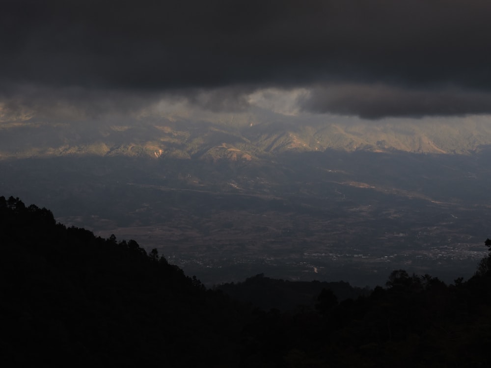 a view of a mountain range under a cloudy sky