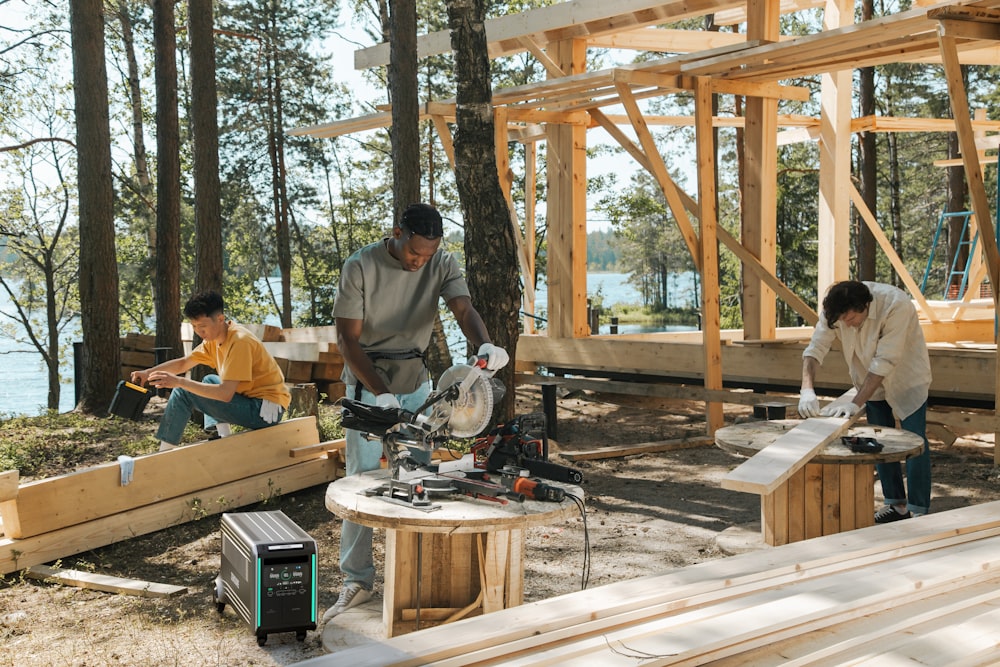 a group of men working on a project in the woods