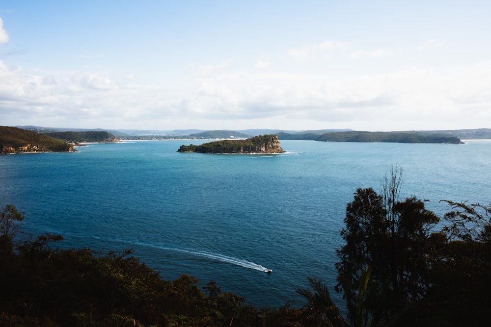 a body of water with a small island in the middle of it