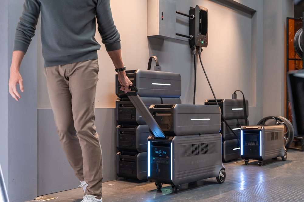 a man standing next to a stack of suitcases