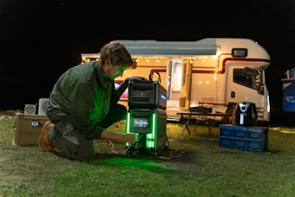 a man kneeling down next to a green light