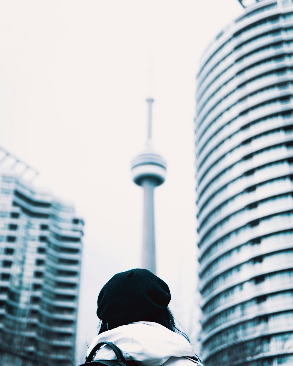 a person standing in front of a tall building