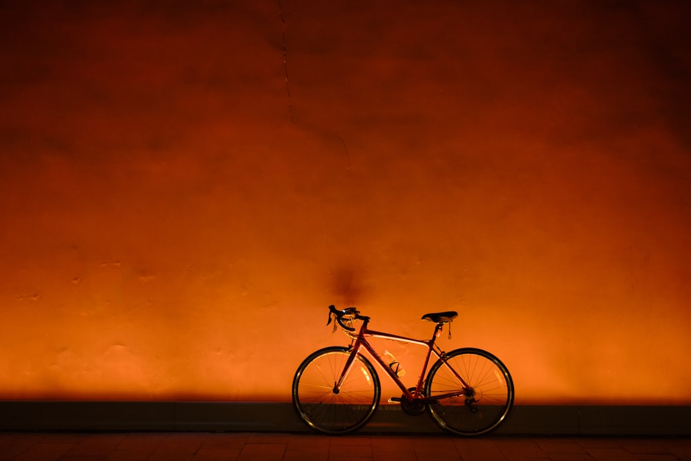 a bike is parked against a wall in a dark room