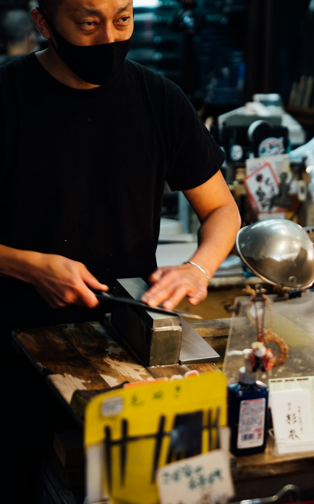 a man in a black shirt is preparing food
