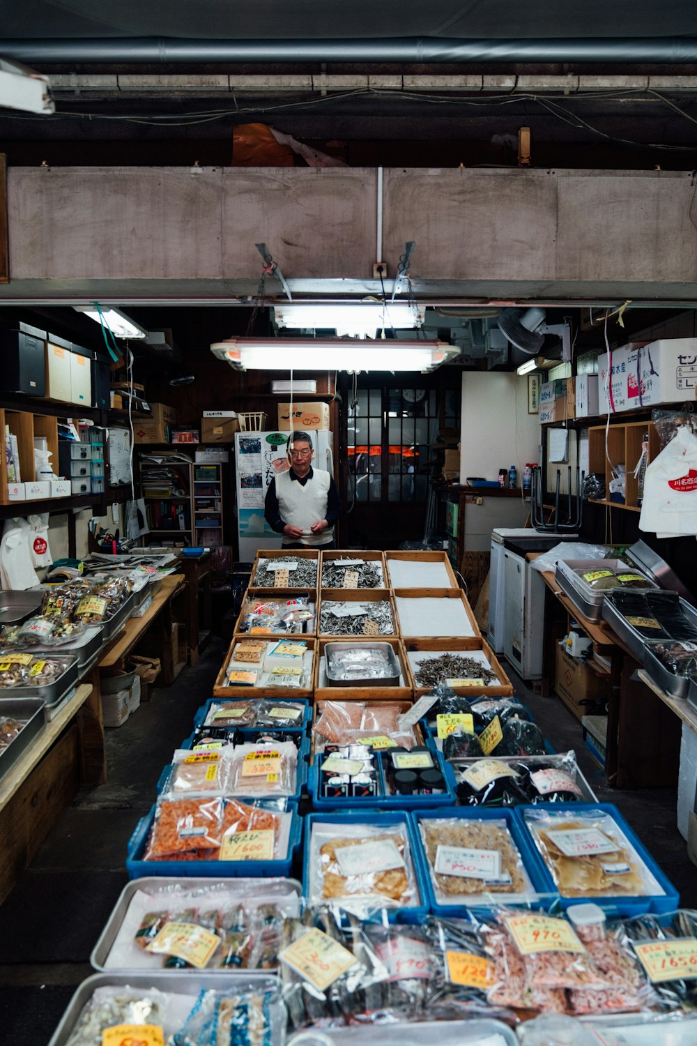 a man standing in a room filled with lots of food