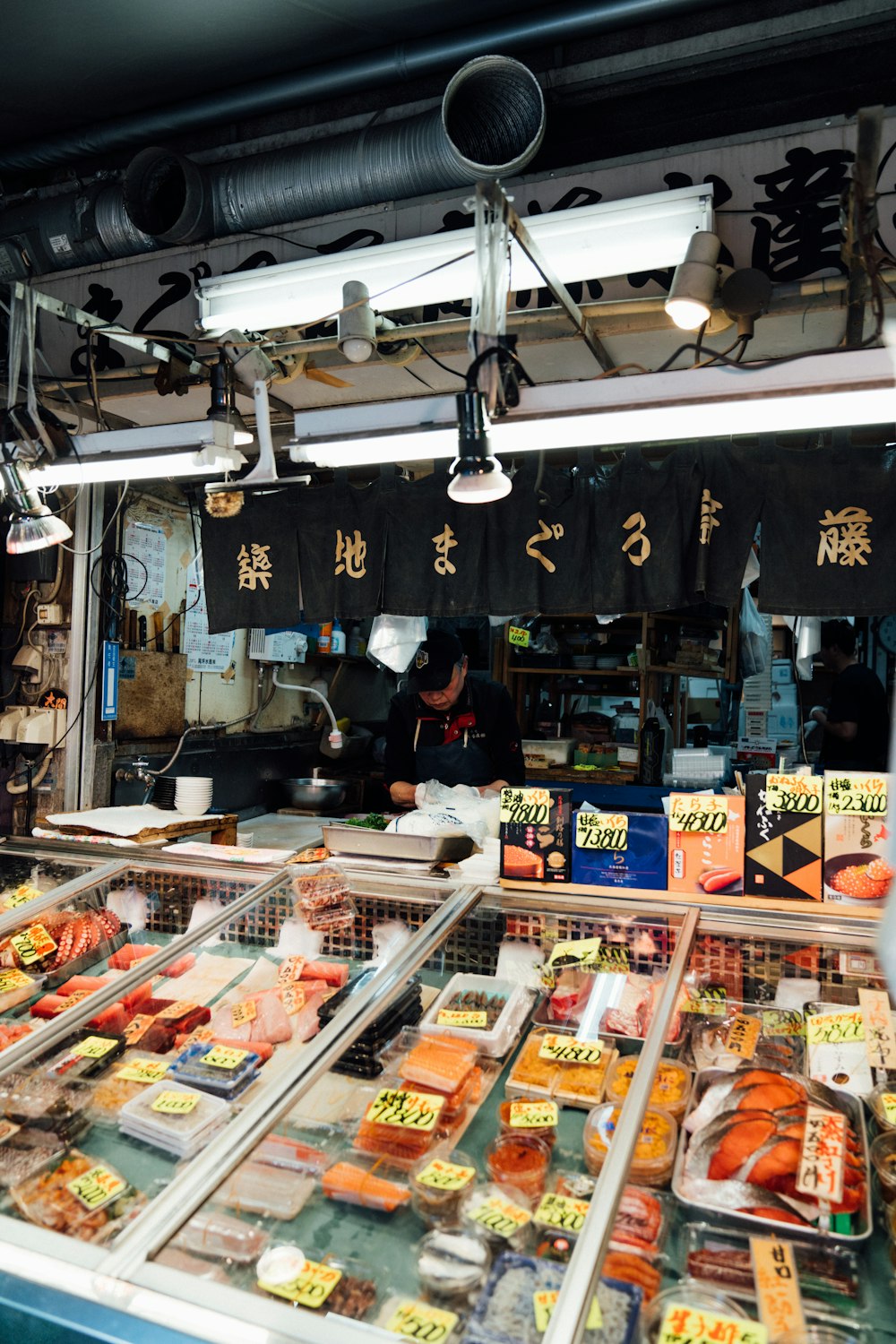 a person standing in front of a food stand