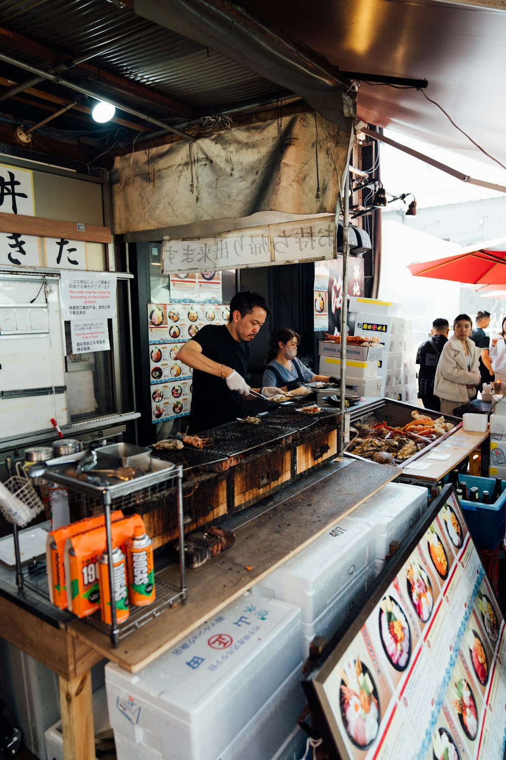 a man cooking food on top of a grill