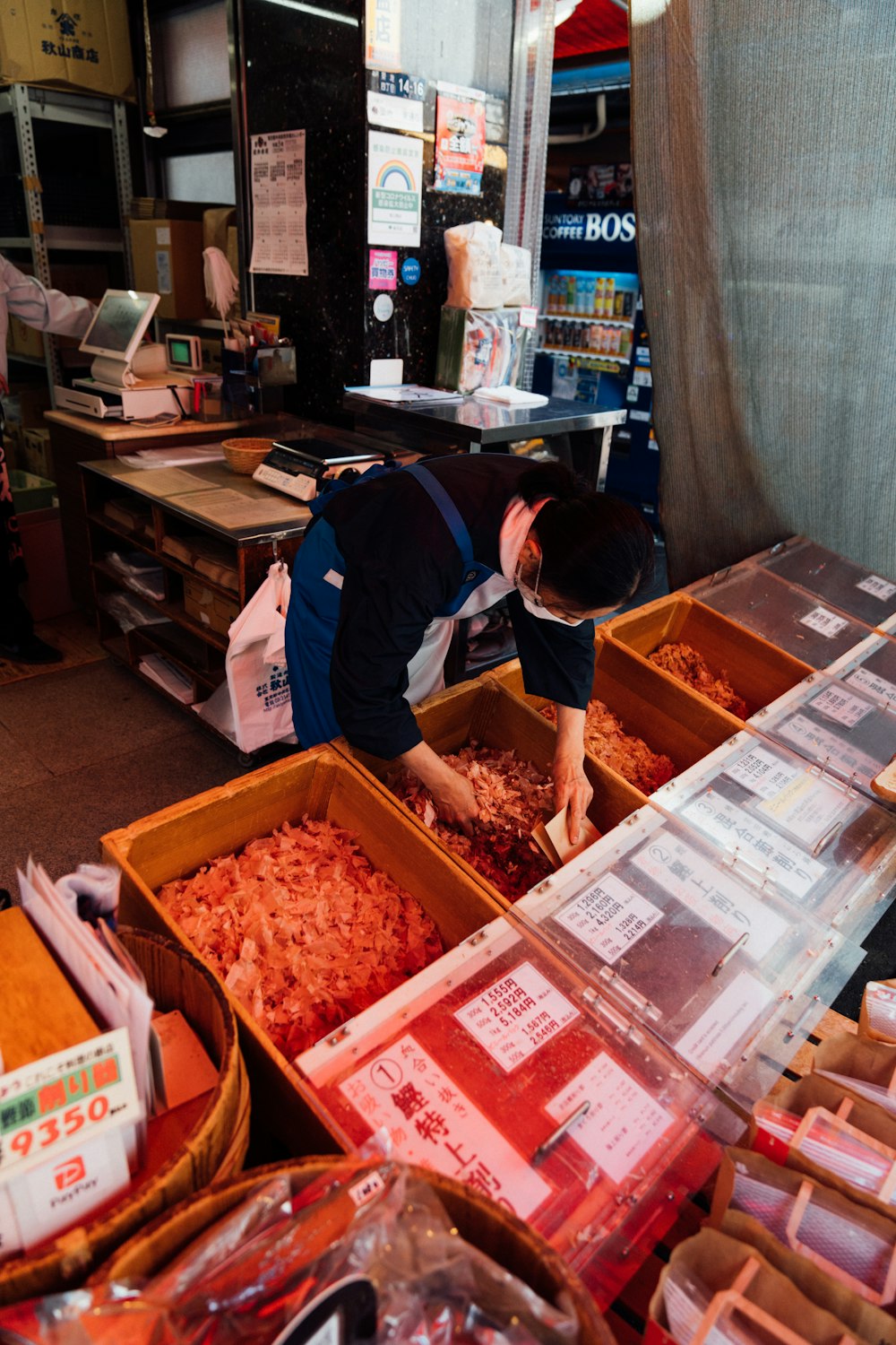 a person standing in a room filled with boxes of food