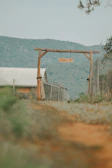 A rustic farm gate with the LMP Dairies Ltd sign welcoming visitors.