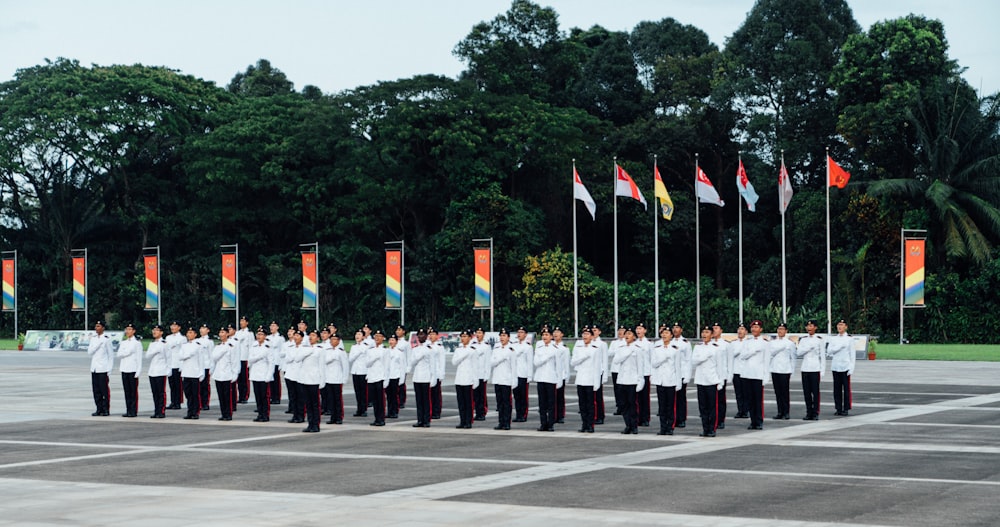 a group of men standing in front of flags