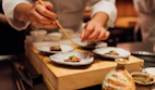 A private chef plating a custom dish in a stylish home kitchen with fresh ingredients.
