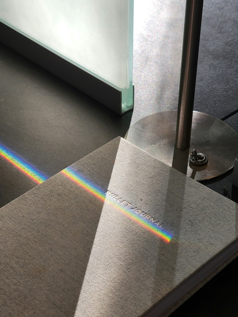 a close up of a metal object with a rainbow pattern on it