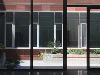 View of the interior courtyard with lush greenery and natural light filtering through.