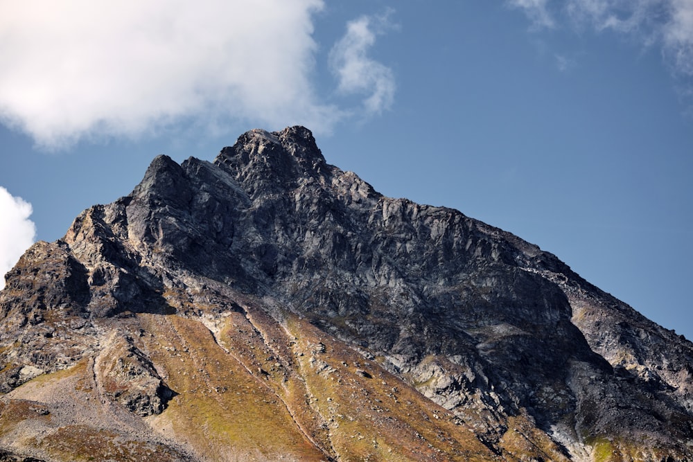 a very tall mountain with a sky in the background