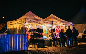 An atmospheric night market stall bathed in green neon, showcasing werkshade’s latest collection.