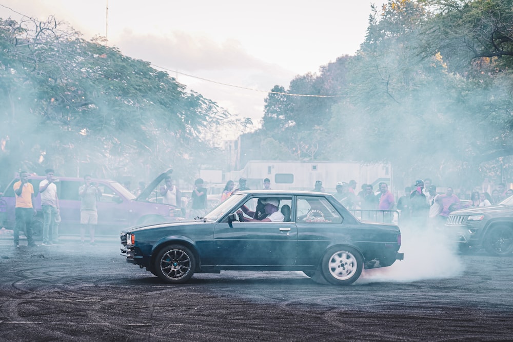 a blue car with smoke coming out of it