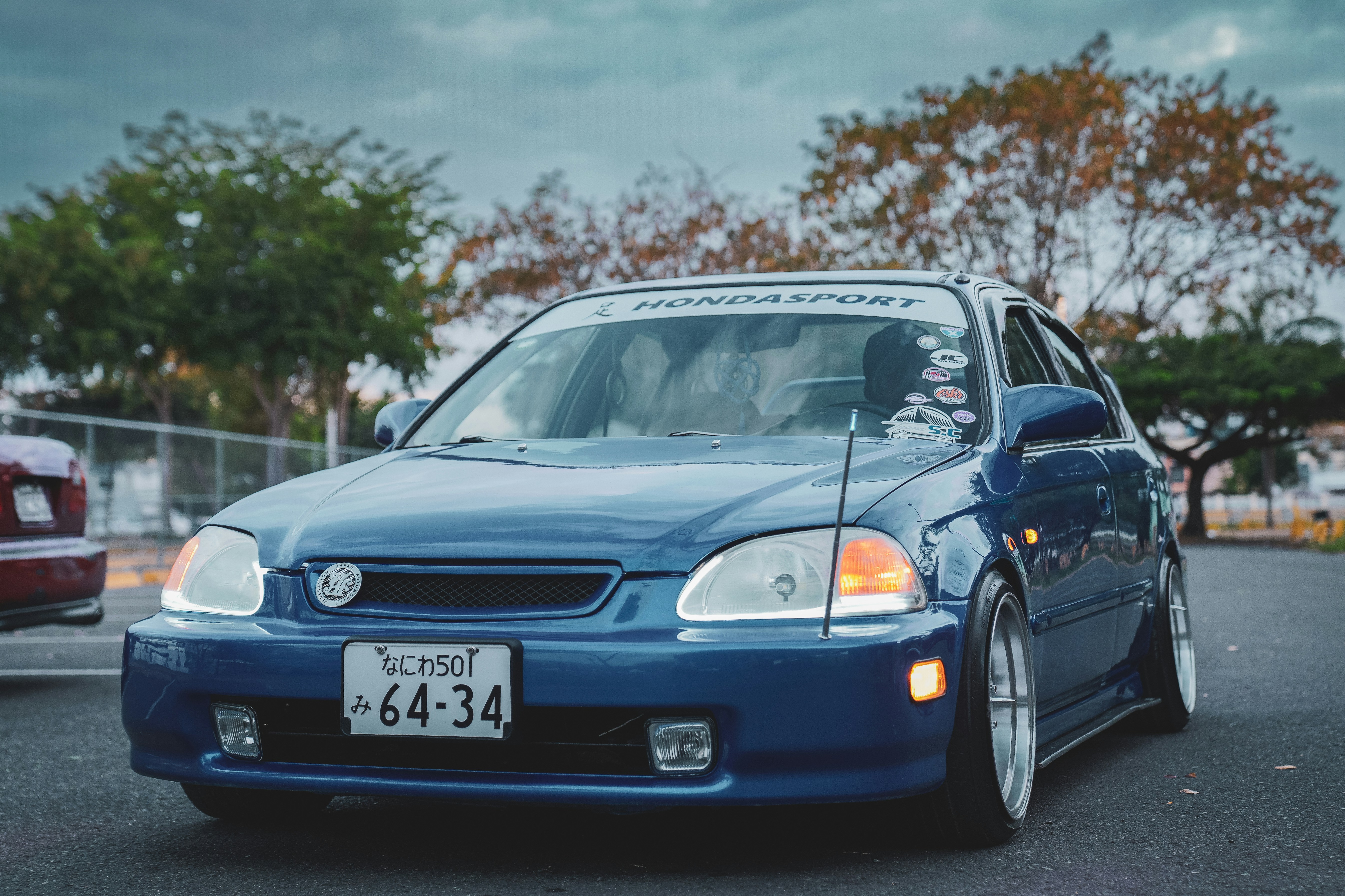 Old blue Honda car outdoors at dusk with dimming lights, designed using precision CAD drafting service
