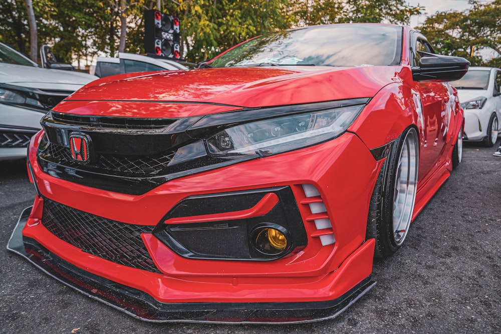 a red sports car parked in a parking lot