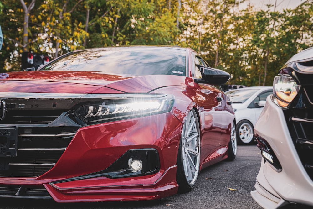 a red car parked next to a white car