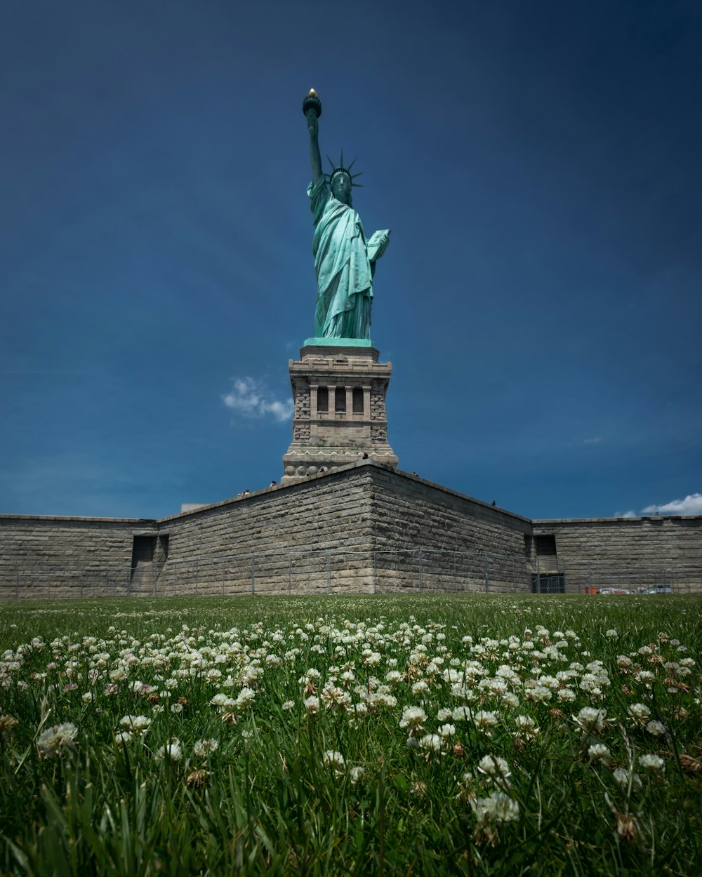 a view of the statue of liberty from the ground