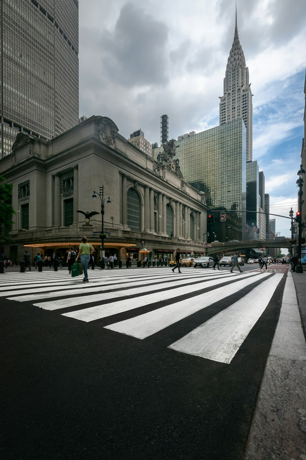 a crosswalk in a large city with tall buildings