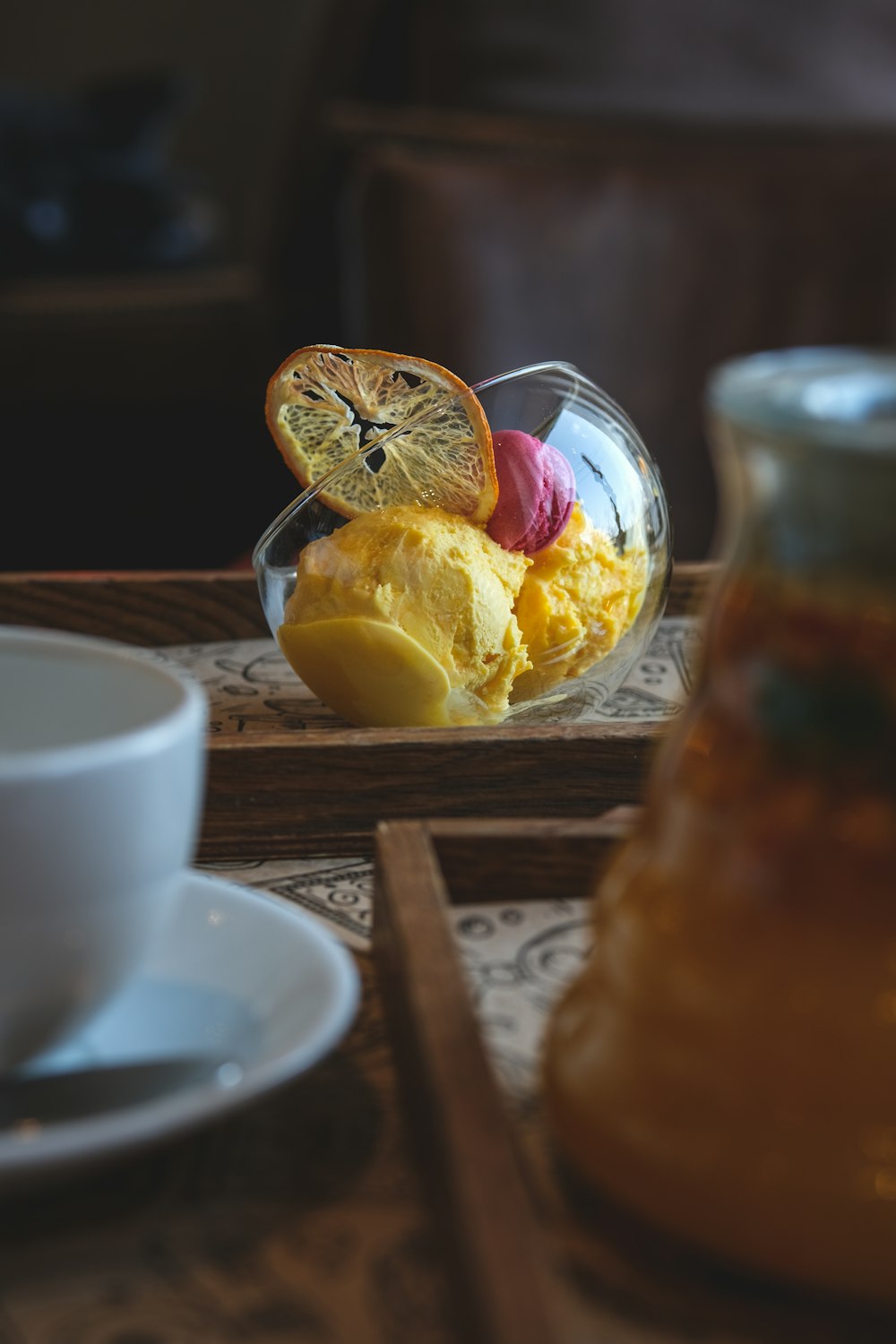 a bowl of fruit and a cup of coffee on a table