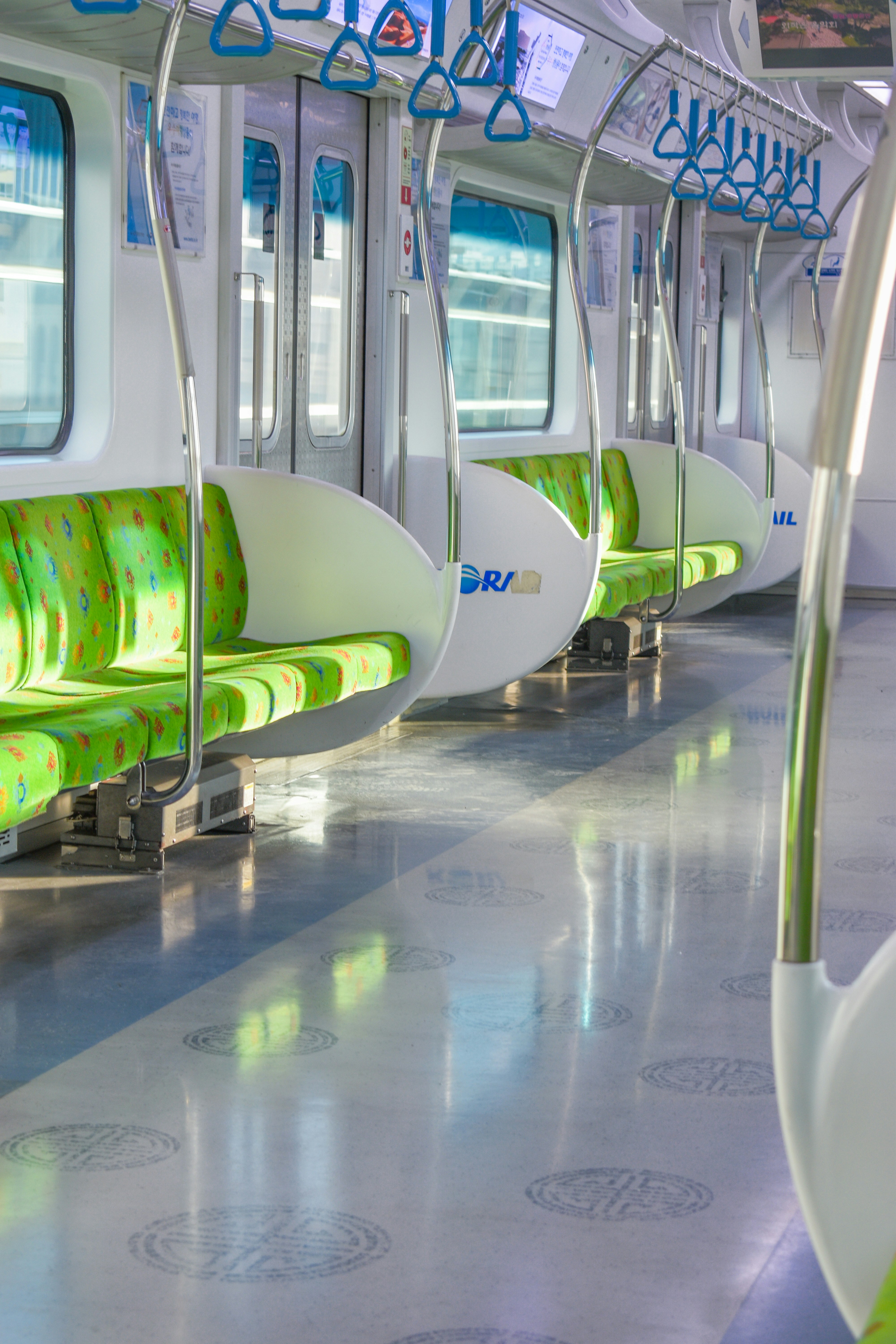 a row of green and white seats on a train