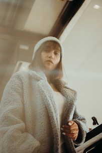 A cozy indoor scene featuring a NewJeans-inspired oversized sweater paired with trendy sneakers.