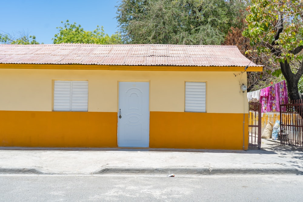 a yellow house with a white door and window