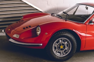 a red sports car parked in a garage