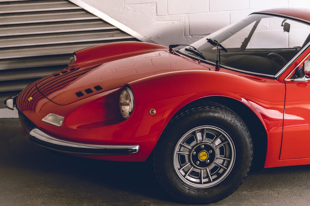 a red sports car parked in a garage