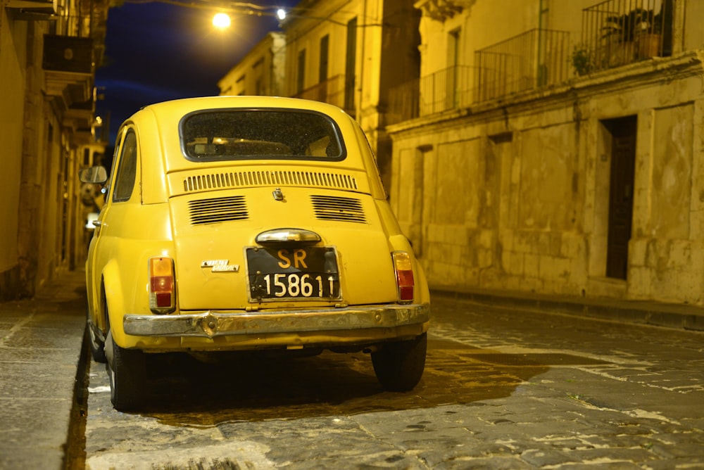 a yellow car parked on the side of a street