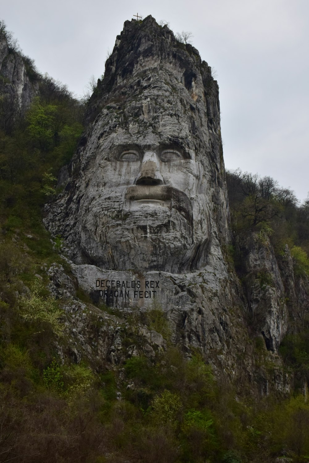 a mountain with a face carved into the side of it
