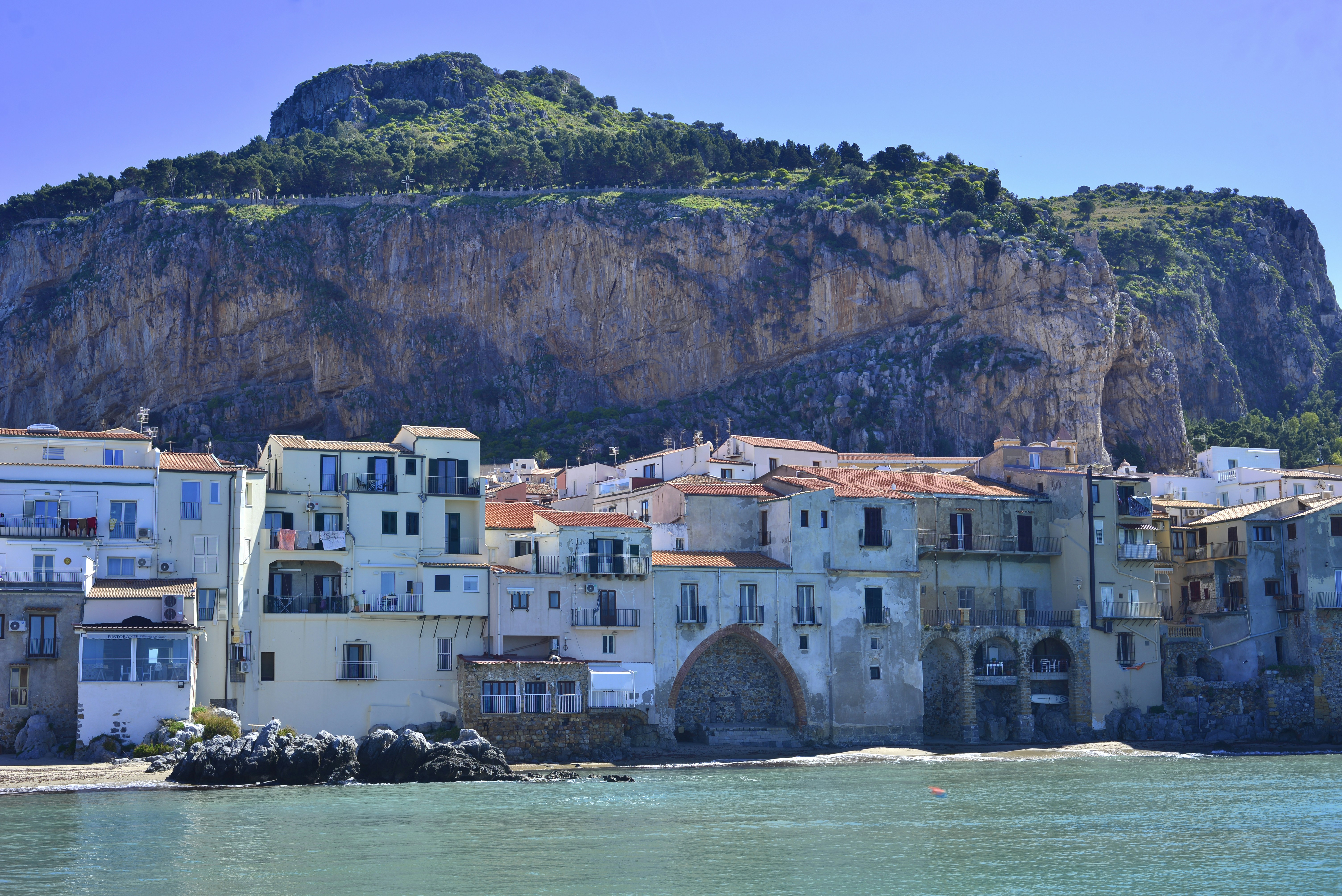 Cefalù old town buildings with La Rocca cliff