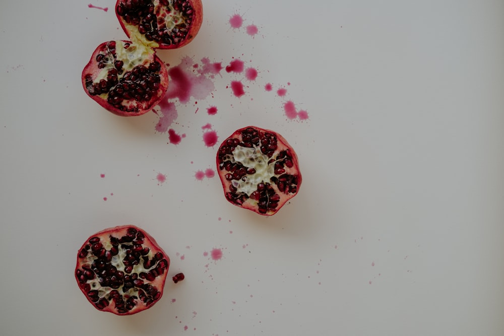 a cut open pomegranate on a white surface