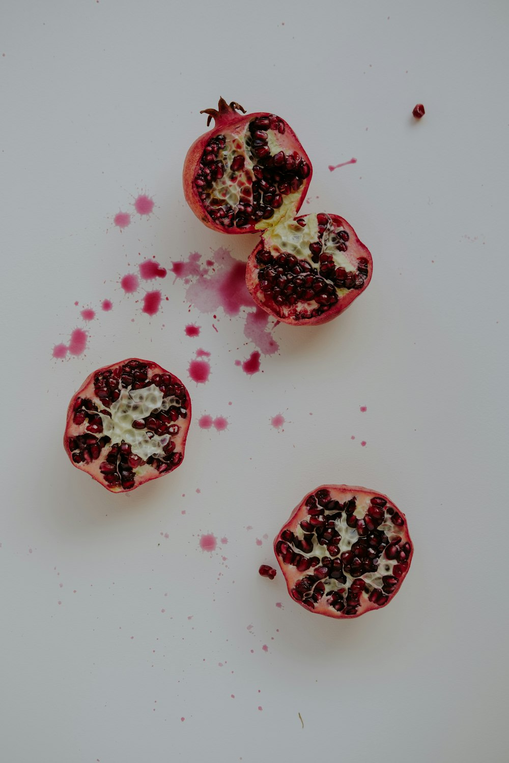 a cut open pomegranate on a white surface