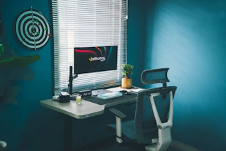 A clean, modern workspace with a laptop displaying tax charts and teal accents.